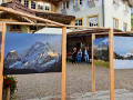 La mostra di pittura organizzata da Dolomiti Unesco in piazza a San Giovanni di Fassa / Sn Jan